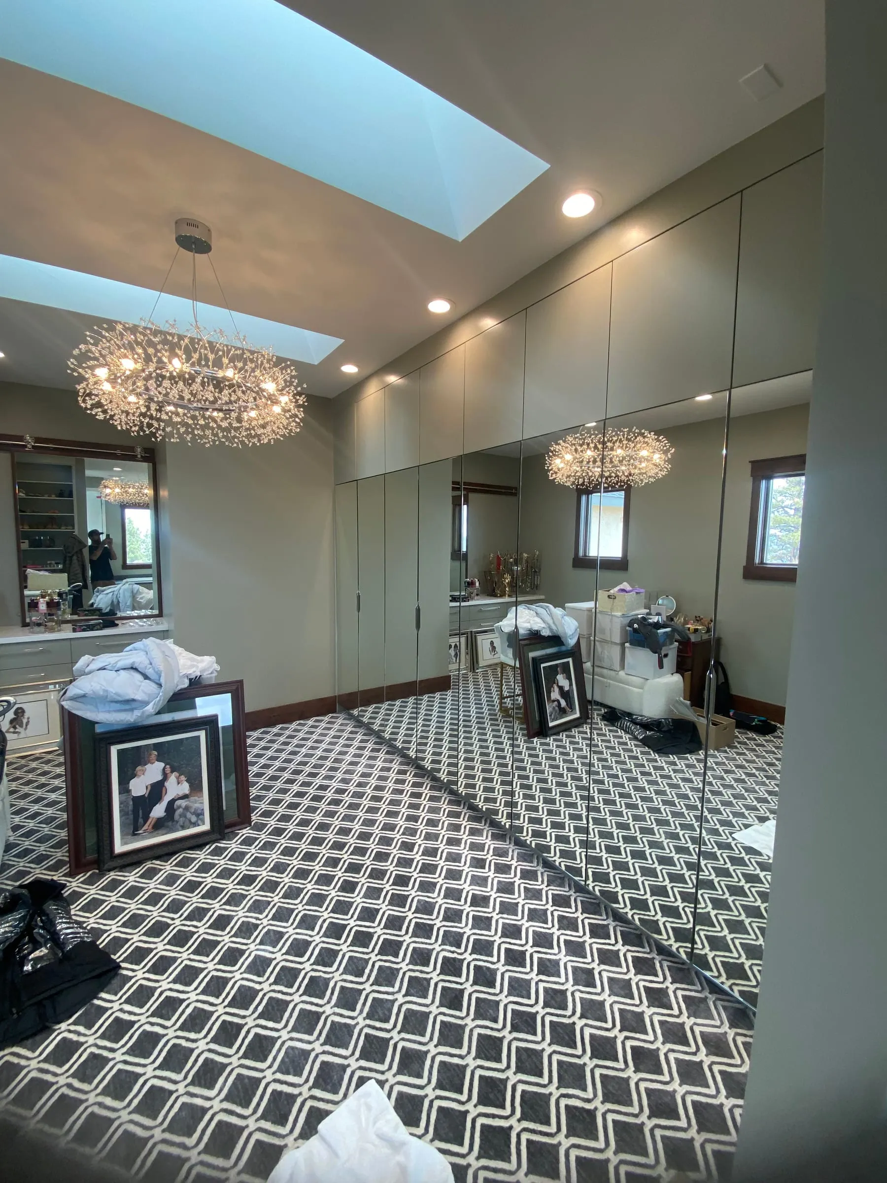 Floor-to-ceiling mirror wall in a dressing room with a chandelier
