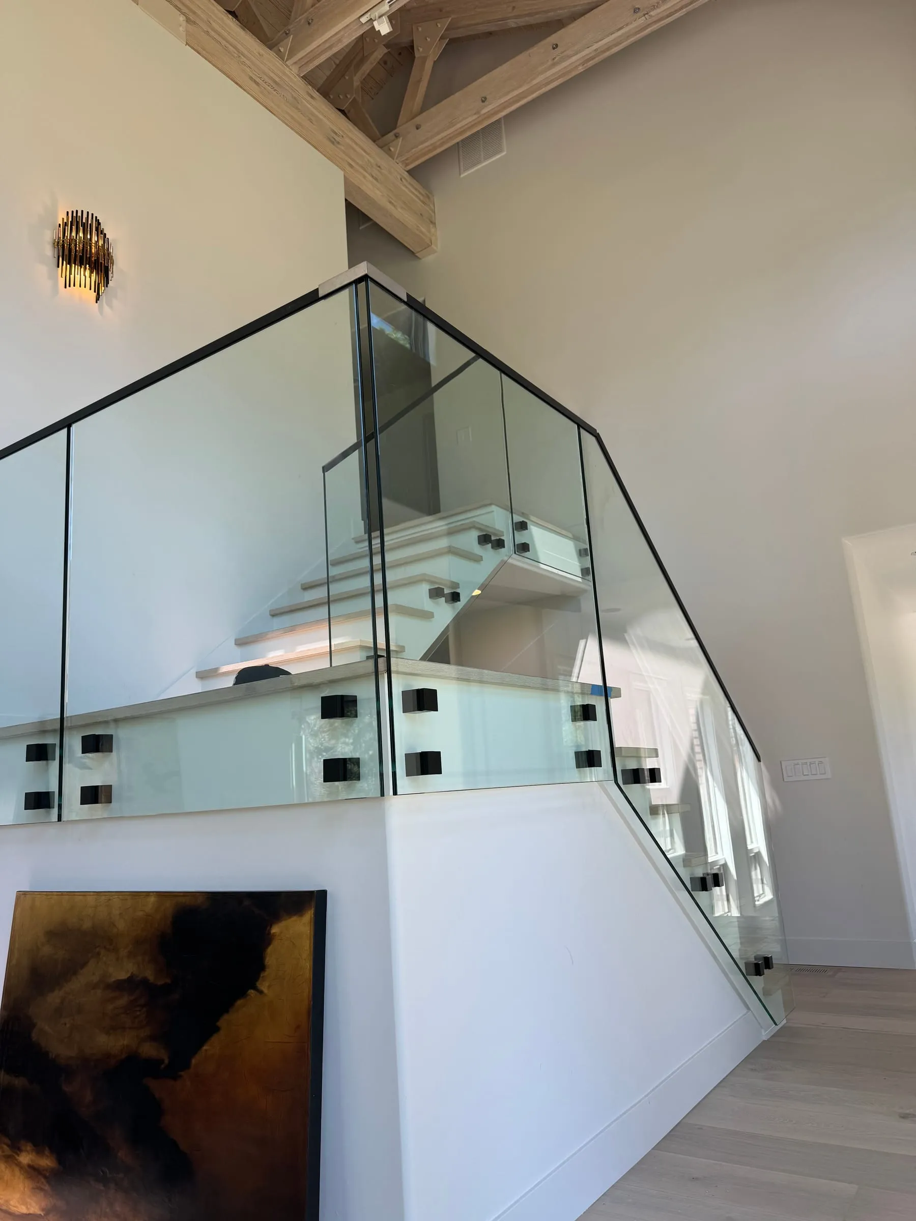Glass stair railing with standoff hardware in a modern home