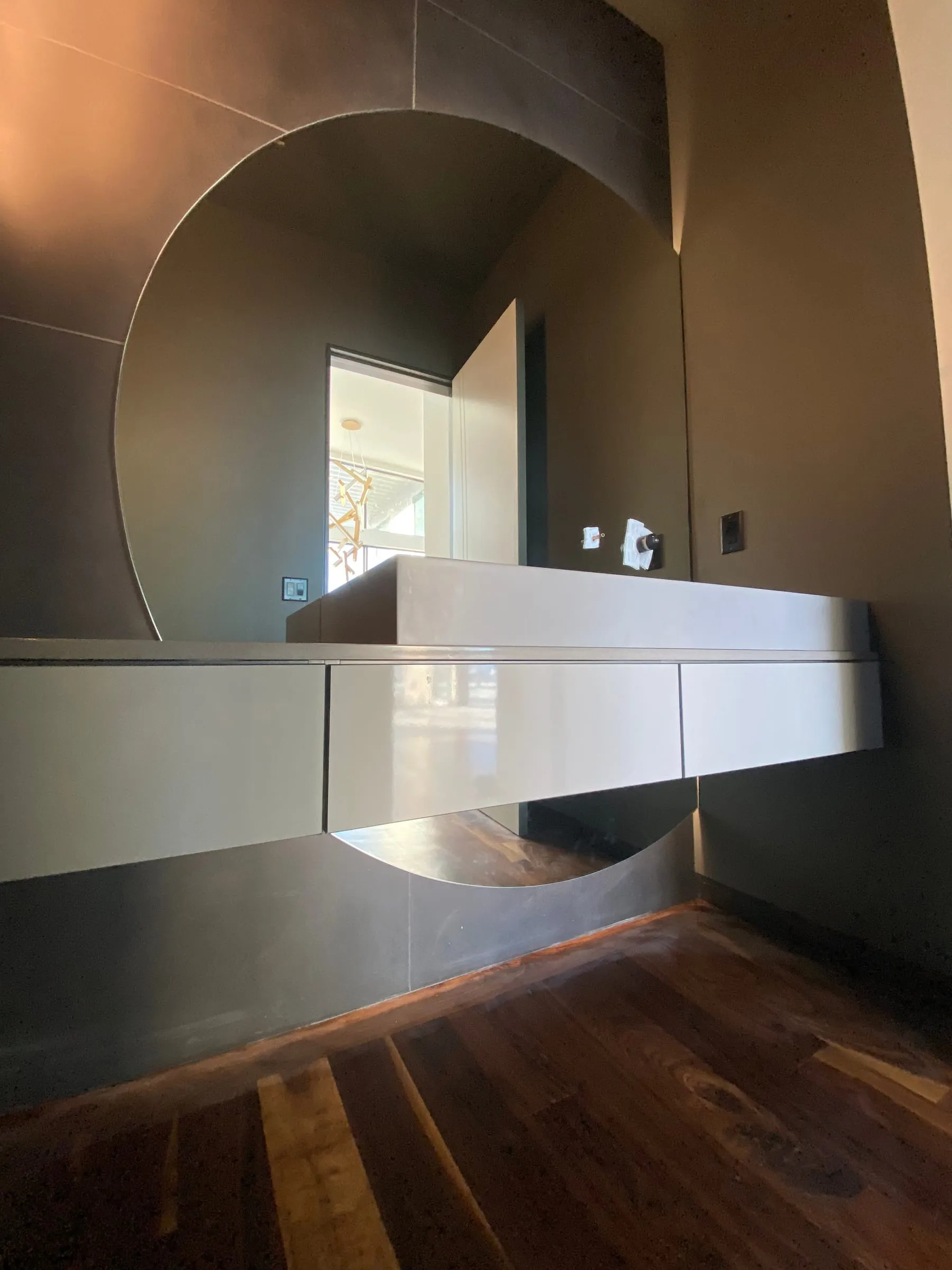 Large custom round mirror in a modern bathroom
