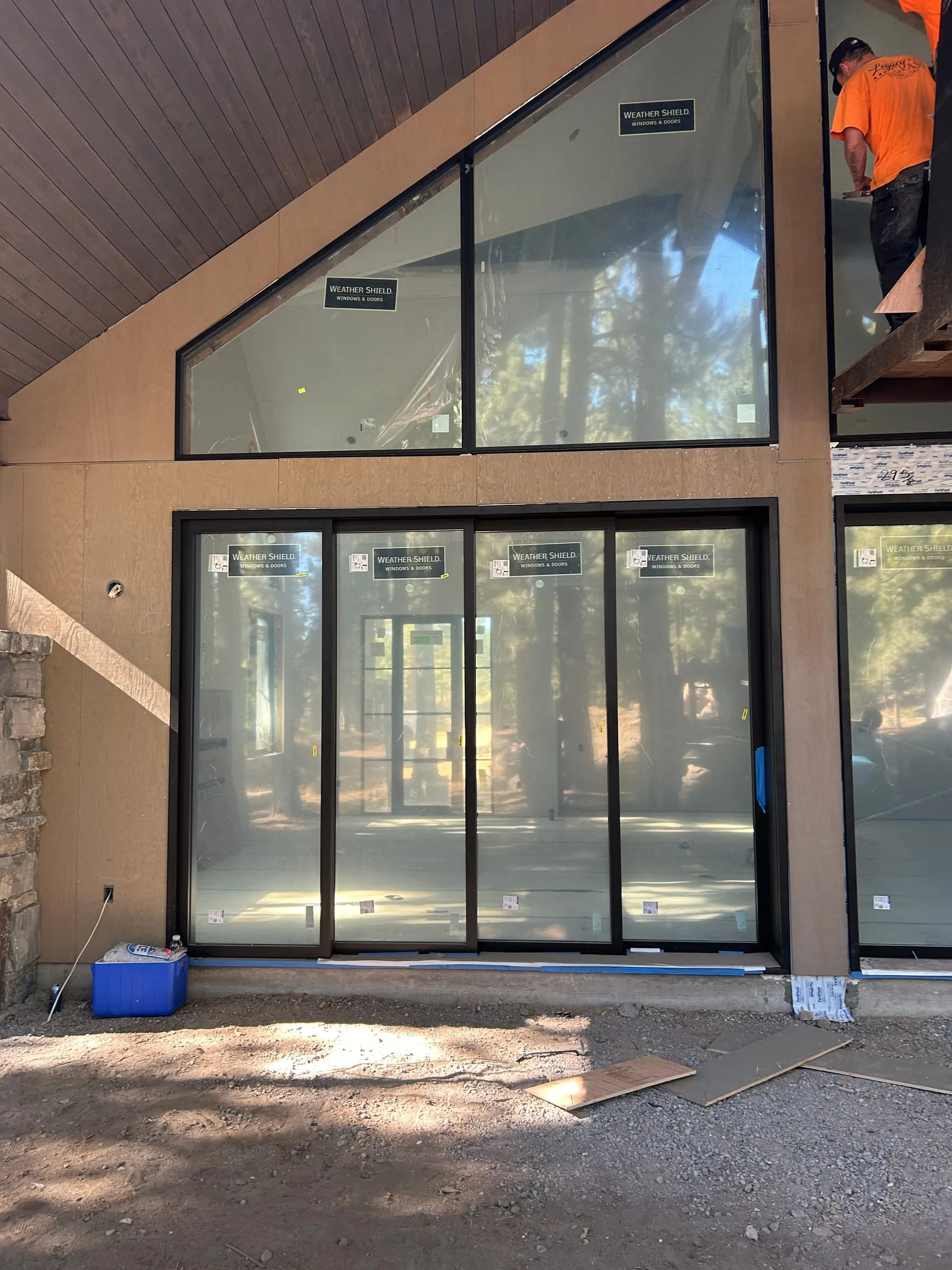 Floor-to-ceiling windows and sliding glass doors installed in a new A-frame home