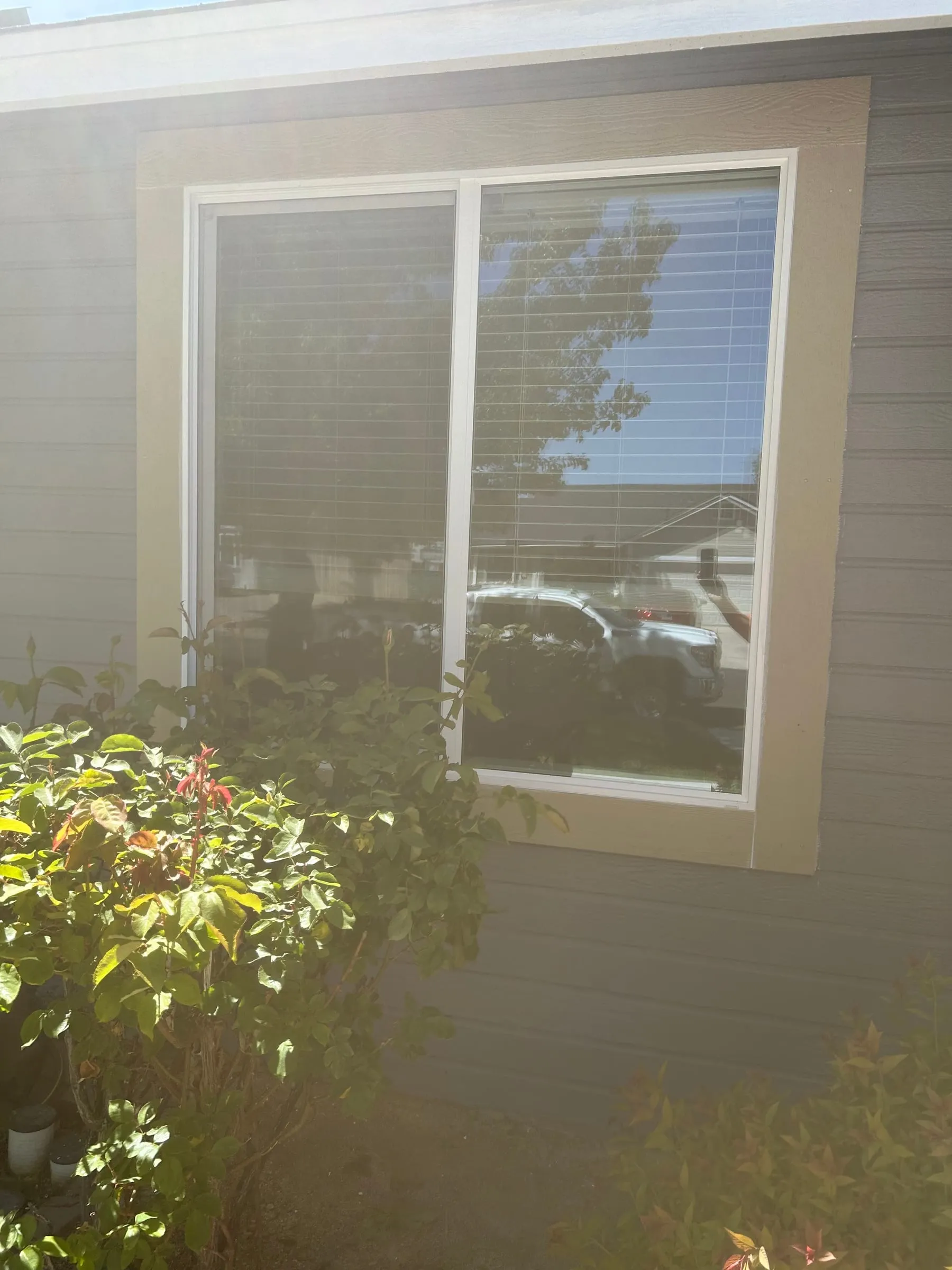 Clear new glass in a white sliding window after repair